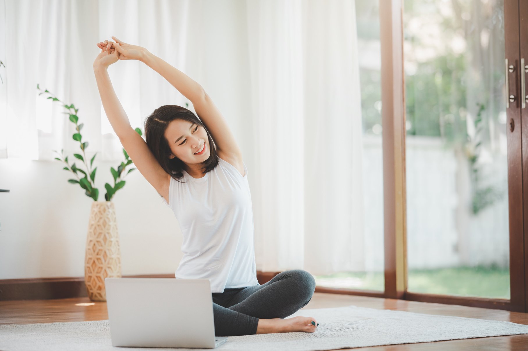 Woman Following an Online Exercise Tutorial  